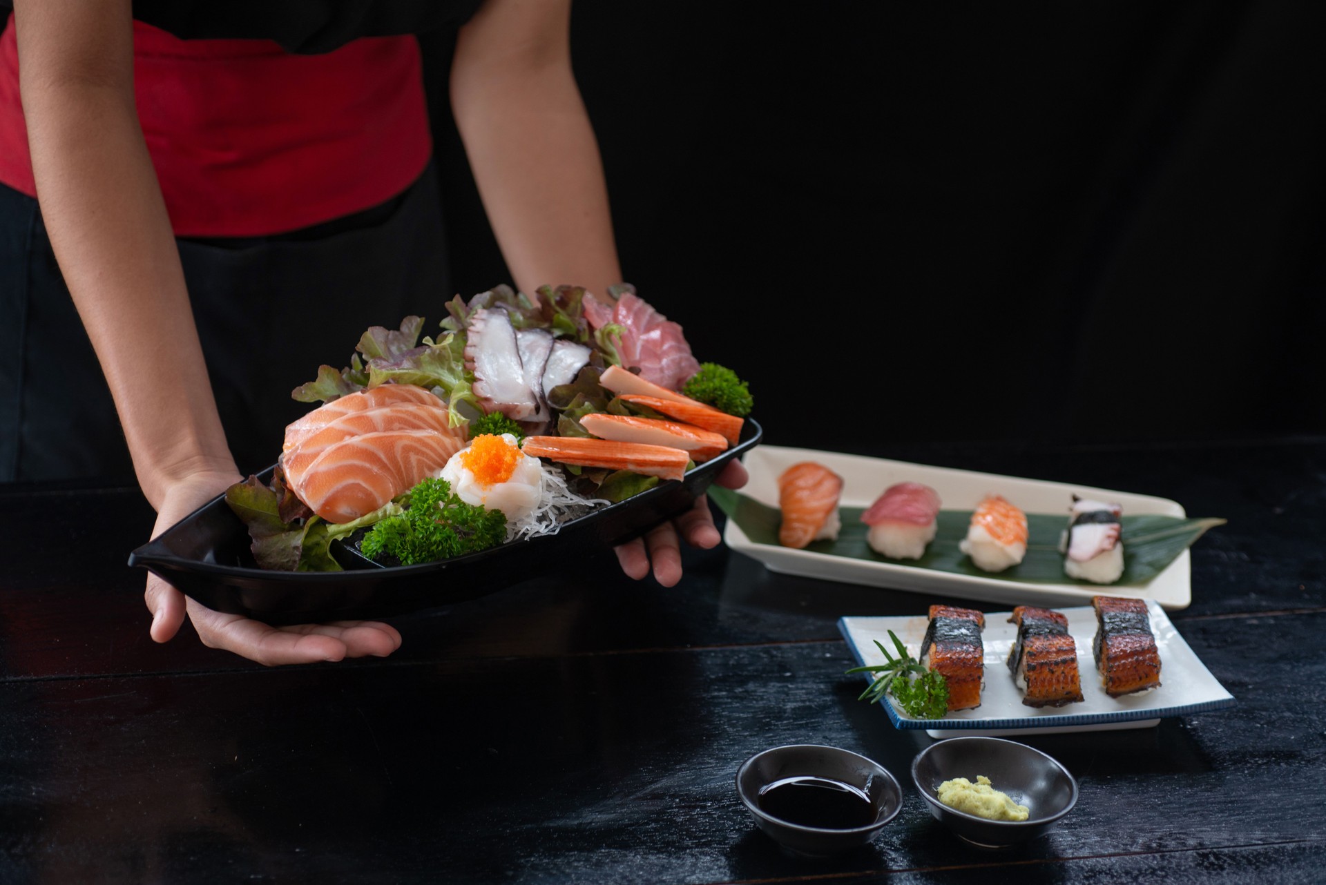 Japanese food chef serves a set of traditional Japanese sashimi